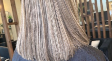 Smooth blonde hair styled at Aphrodite in Stirling, Scotland, GB showcasing expert salon quality.