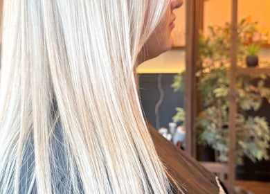 Sleek blonde hair styled at Aphrodite in Stirling, Scotland, GB. Modern salon ambiance.
