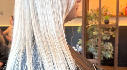 Sleek blonde hair styled at Aphrodite in Stirling, Scotland, GB. Modern salon ambiance.