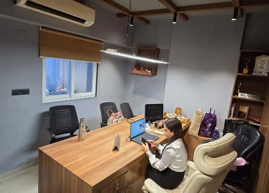 Modern office space at Skintude in Ahmedabad, Gujarat, IN with wood desk and stylish seating.