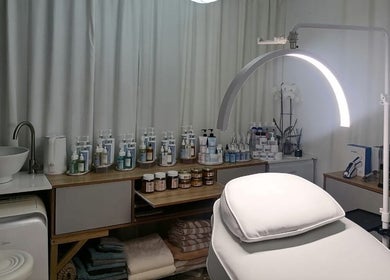Treatment room at Dream Skin Aesthetics in Stanford, Western Cape, ZA, showcasing skincare products and equipment.