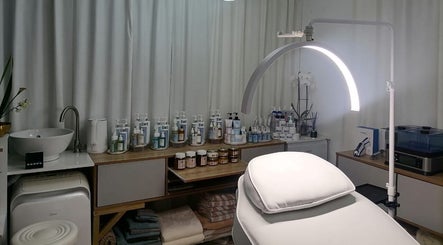 Treatment room at Dream Skin Aesthetics in Stanford, Western Cape, ZA, showcasing skincare products and equipment.