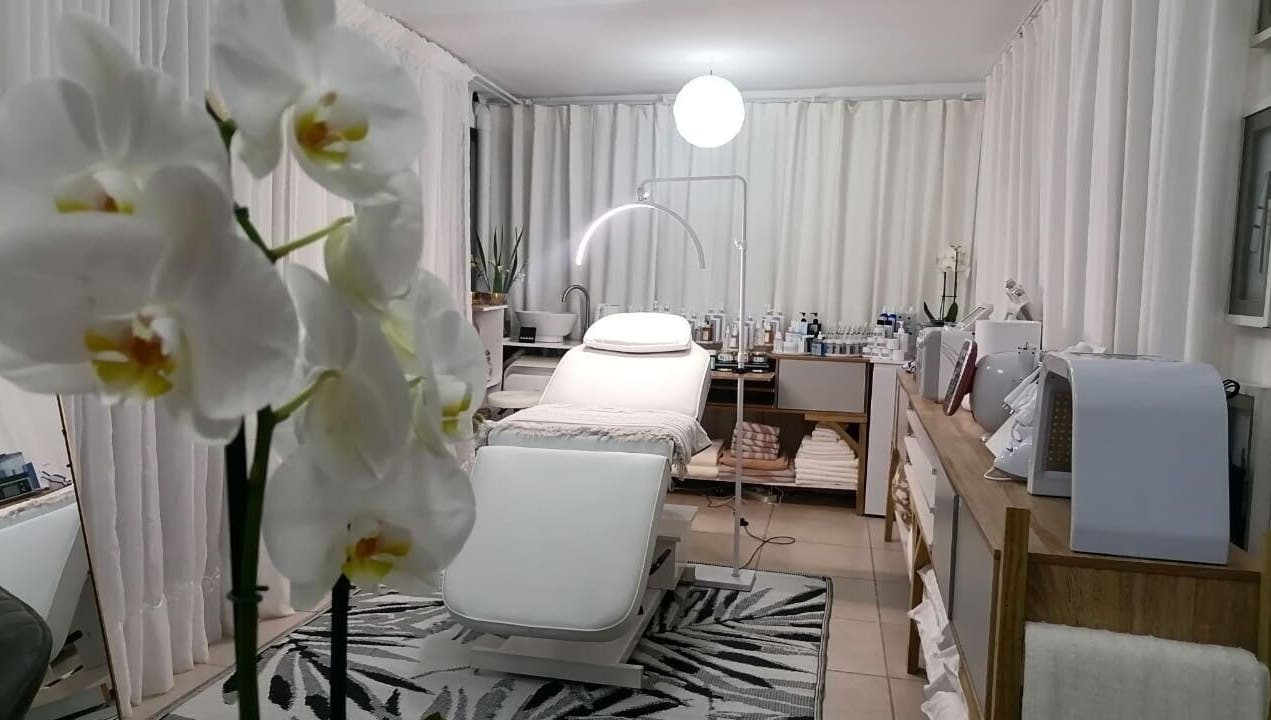 Elegant treatment room at Dream Skin Aesthetics, Stanford, Western Cape, ZA with orchids and modern decor.