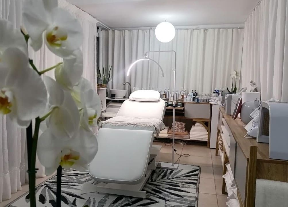 Elegant treatment room at Dream Skin Aesthetics, Stanford, Western Cape, ZA with orchids and modern decor.