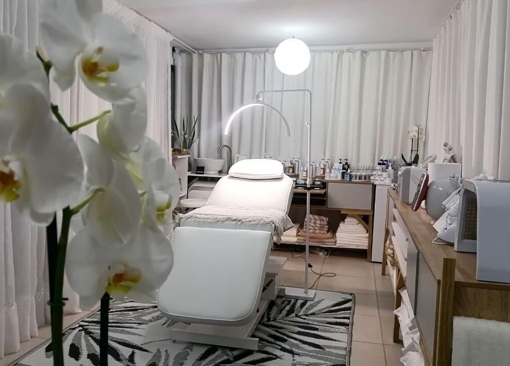 Elegant treatment room at Dream Skin Aesthetics, Stanford, Western Cape, ZA with orchids and modern decor.