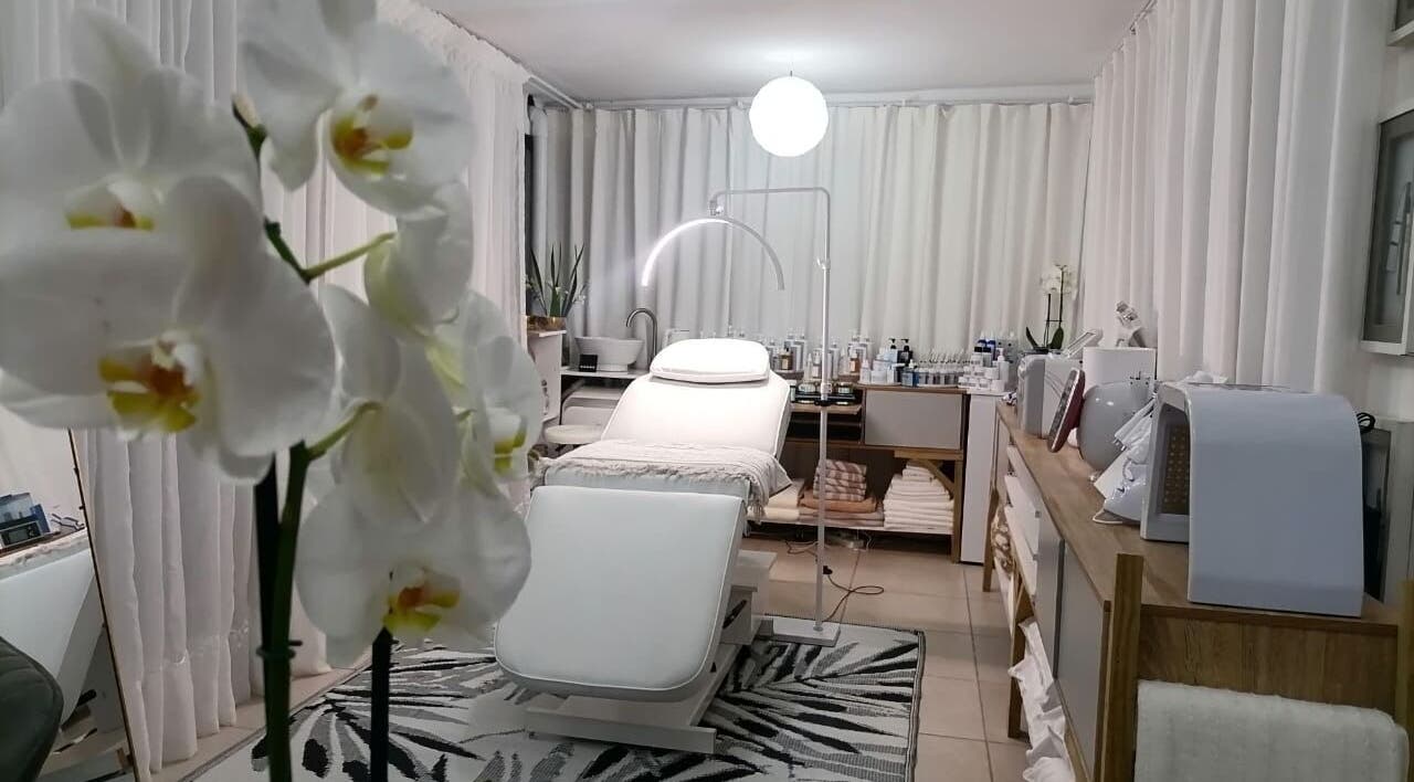 Elegant treatment room at Dream Skin Aesthetics, Stanford, Western Cape, ZA with orchids and modern decor.