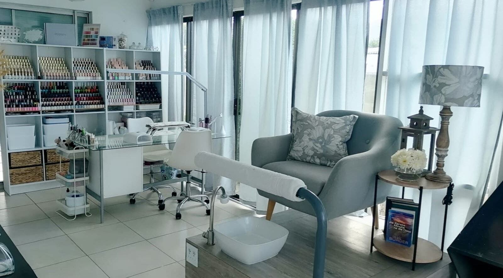 Chic nail salon at Dream Skin Aesthetics, Stanford, Western Cape, ZA with pastel decor and plush seating.