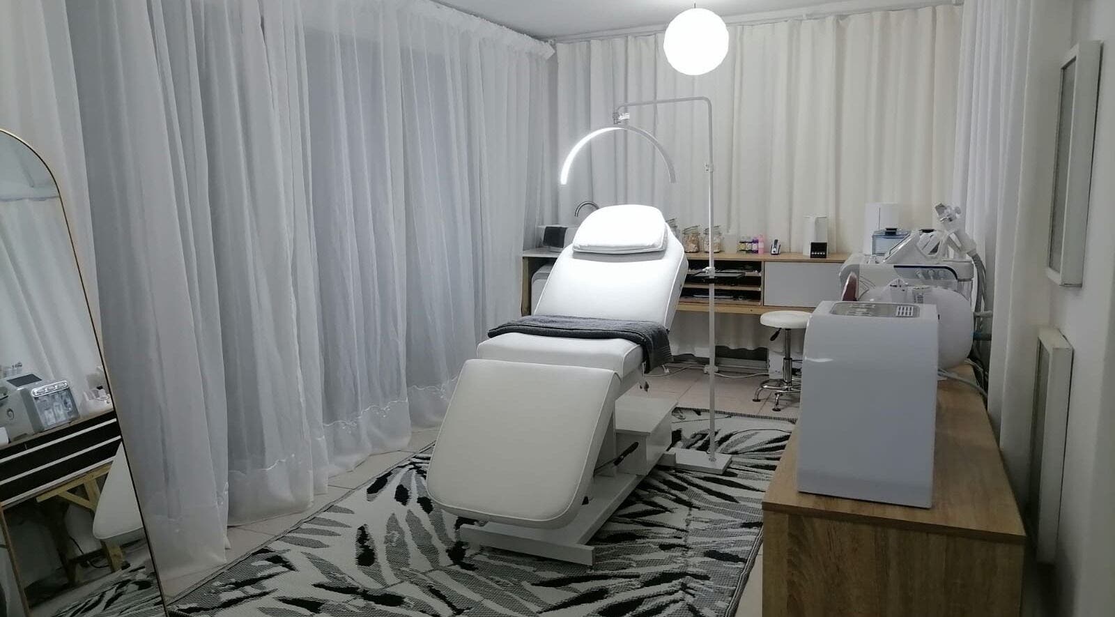 Serene treatment room at Dream Skin Aesthetics, Stanford, Western Cape, ZA with modern spa chair and ambient lighting.