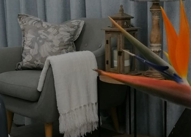 Cozy seating and exotic plant at Dream Skin Aesthetics in Stanford, Western Cape, ZA.