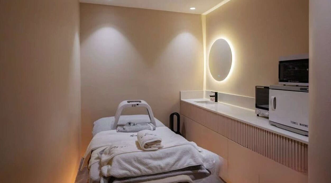 Cozy massage room at Living Well Massage Town Hall, Sydney, New South Wales, AU, with warm lighting and amenities.