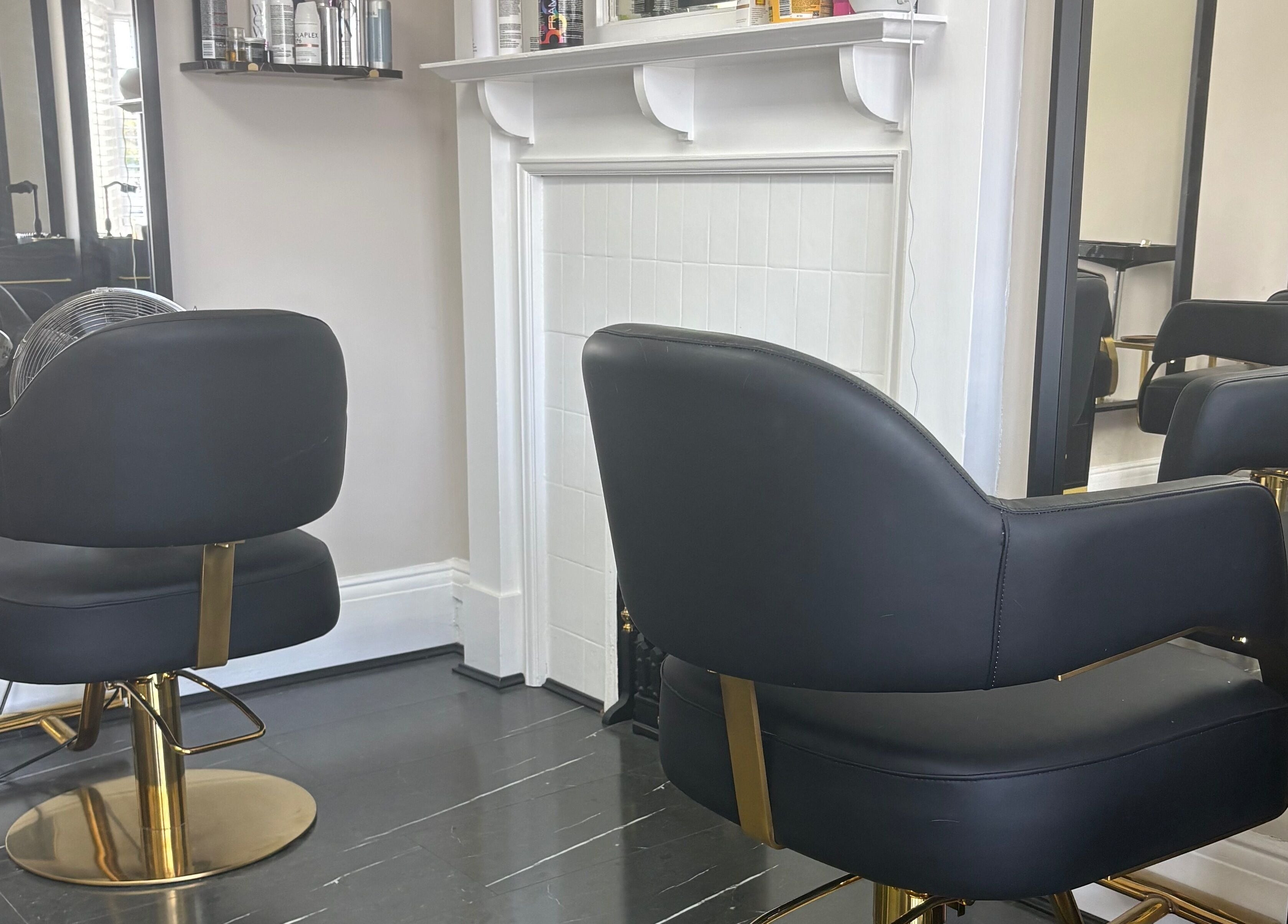 Elegant black salon chairs at Hair by Hannah in Bentley Heath, England, GB, providing a luxurious experience.