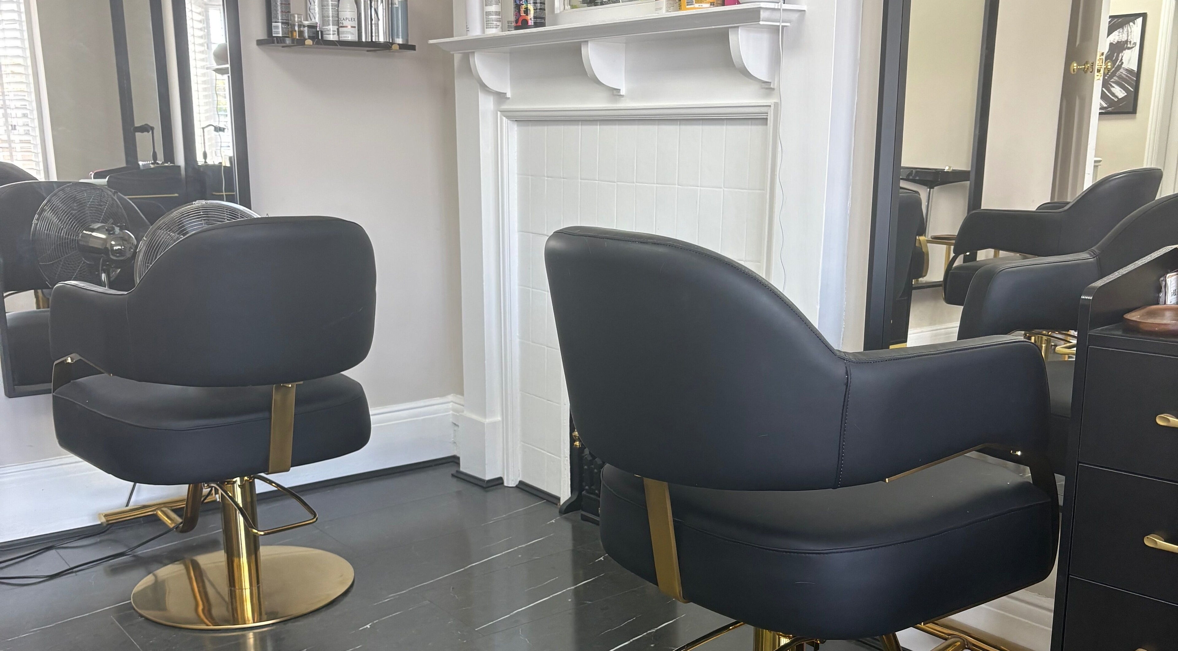 Elegant black salon chairs at Hair by Hannah in Bentley Heath, England, GB, providing a luxurious experience.