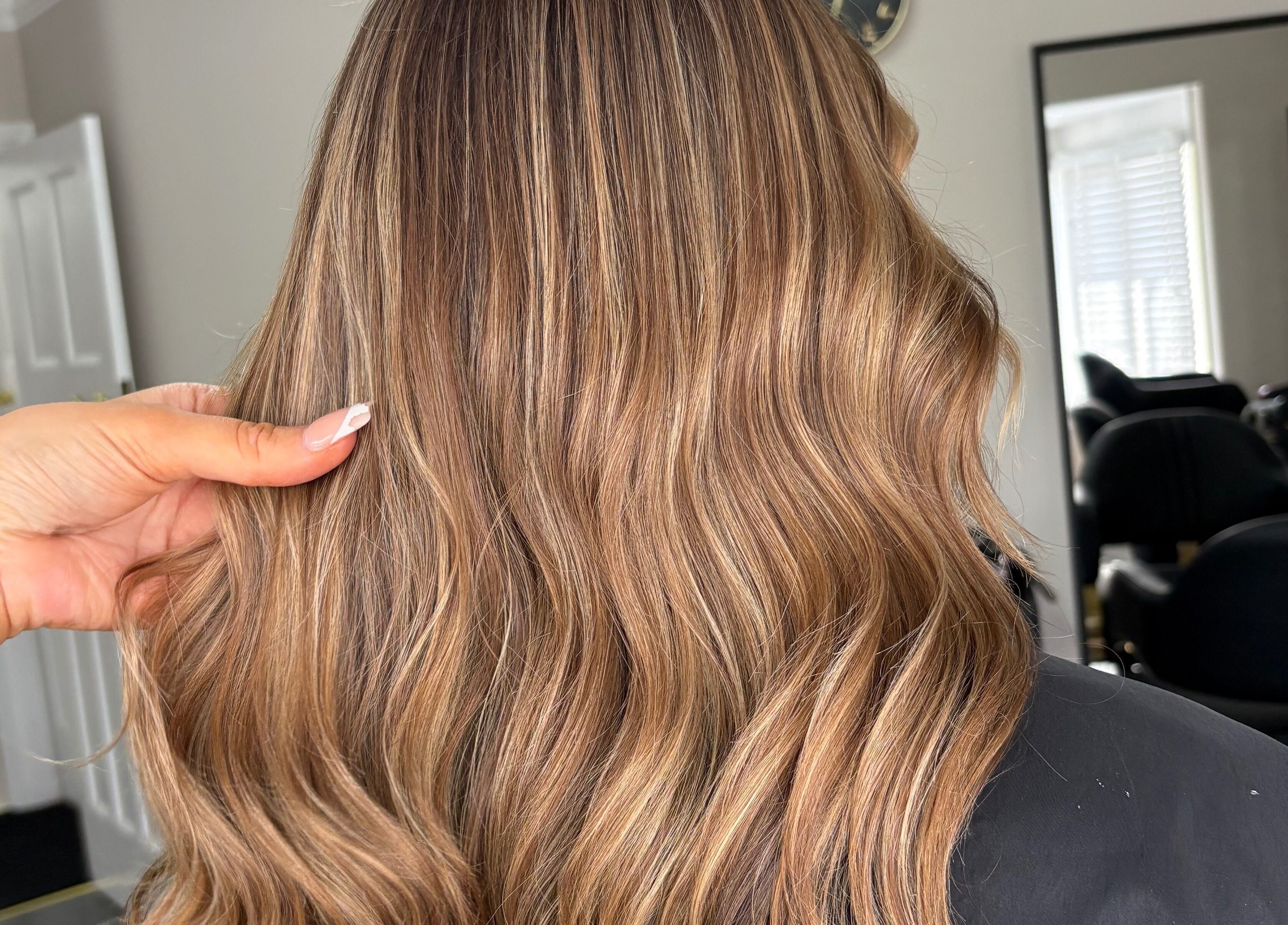 Styled wavy hair at Hair by Hannah, Bentley Heath, England, GB showcasing vibrant color and shine.