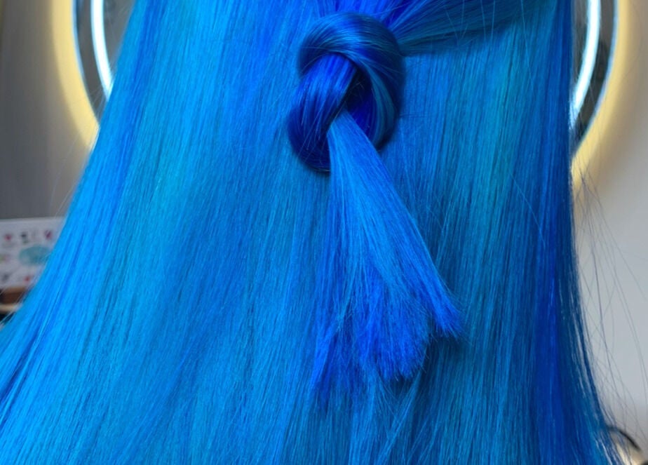Vibrant blue hair styled in a knot at Hair by Hannah, Bentley Heath, England, GB.