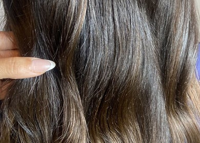 Close-up of silky hair extensions at SAW Hair Extensions, Nottingham, England, GB showcasing rich texture.