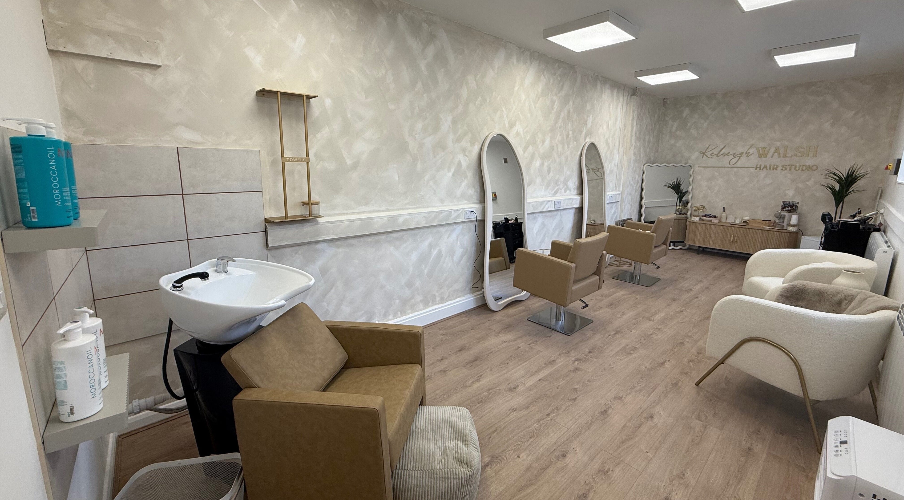 Modern interior of Kelseigh Walsh Hair - Studio, Anstey, England, GB, with stylish salon chairs and mirrors.