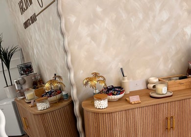 Elegant refreshment corner at Kelseigh Walsh Hair - Studio in Anstey, England, GB with wooden decor and refreshments.