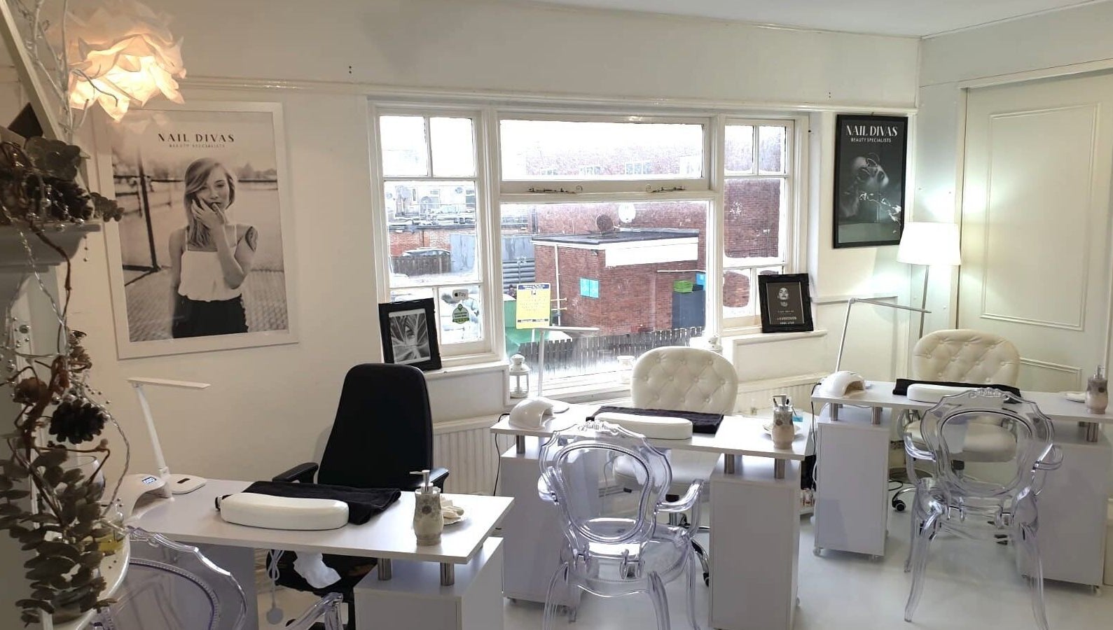 Cozy interior of Nail Divas, Newport, Wales, GB showcasing elegant nail treatment stations.