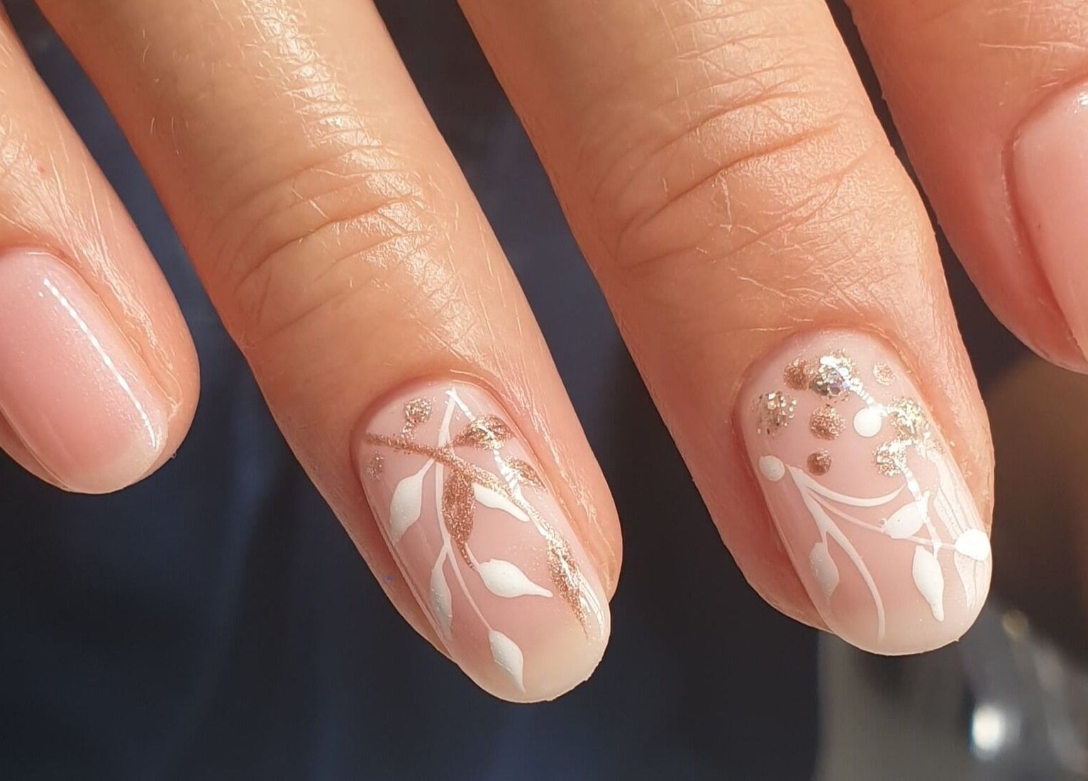 Close-up of elegant nail design at Nail Divas, Newport, Wales, GB, featuring delicate floral patterns.