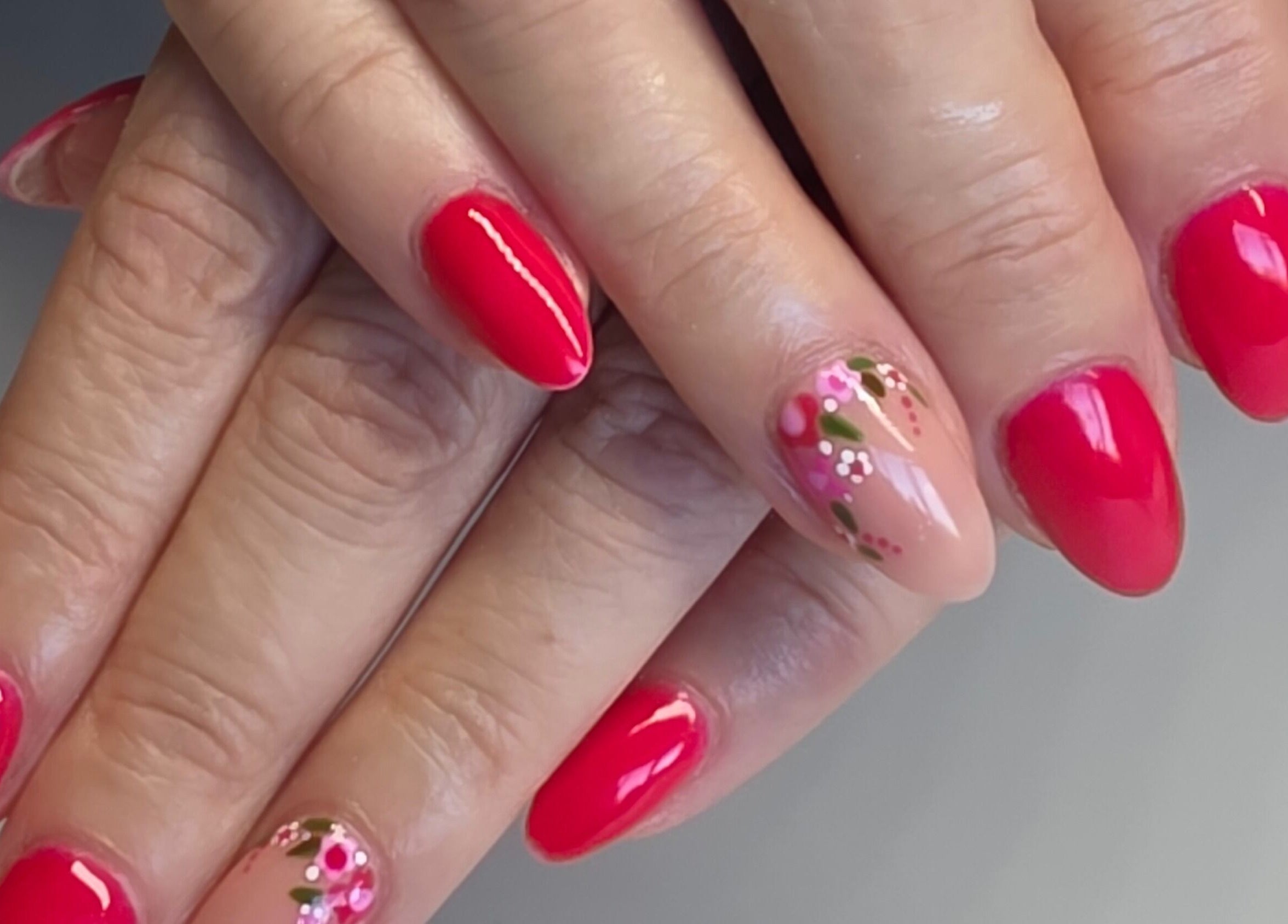 Beautiful floral nail art in vibrant red at Nail Divas, Newport, Wales, GB.