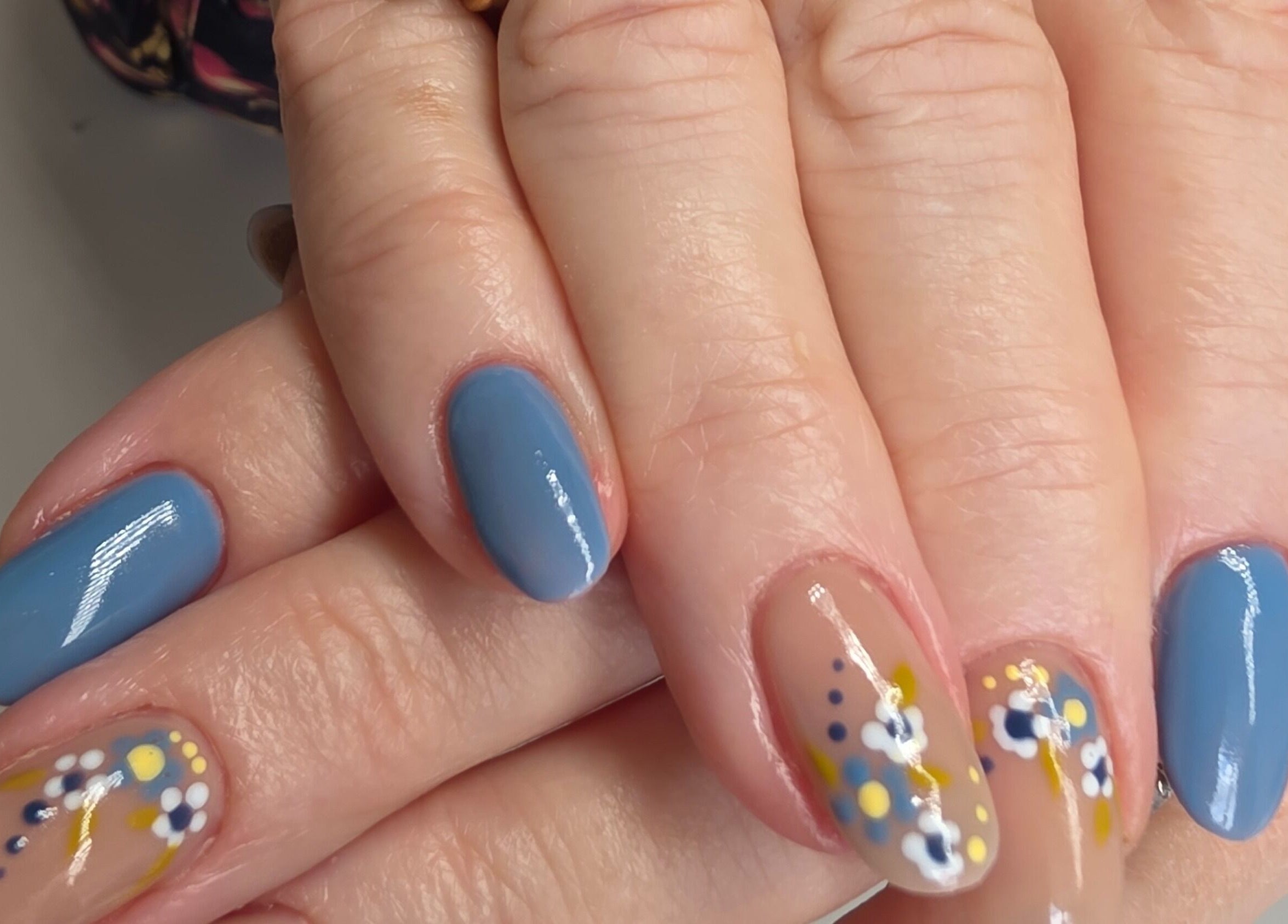 Elegant blue and floral nail design at Nail Divas, Newport, Wales, GB.