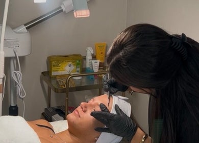 Aesthetician at Hurley Aesthetics, Blaxton, England GB, expertly performing a facial treatment on a client.