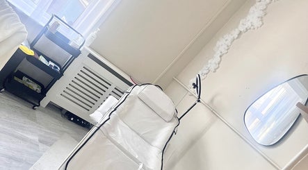 Treatment room at Studio H Aesthetics, Barbers & Hair, Norwich, England, GB with a therapy bed and modern decor.