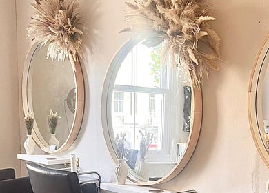Studio H Aesthetics, Barbers & Hair in Norwich, England, GB with stylish mirrors and cozy chairs.