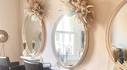 Studio H Aesthetics, Barbers & Hair in Norwich, England, GB with stylish mirrors and cozy chairs.