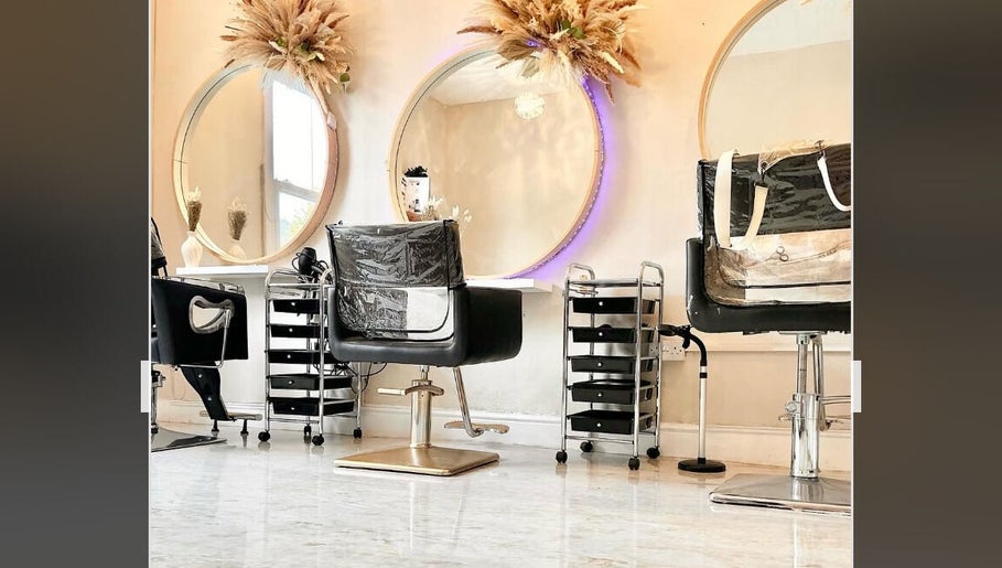 Stylish salon chairs and round mirrors at H Derma Beauti Aesthetics & Hair, Norwich, England, GB.
