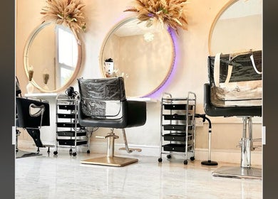 Stylish salon chairs and round mirrors at H Derma Beauti Aesthetics & Hair, Norwich, England, GB.