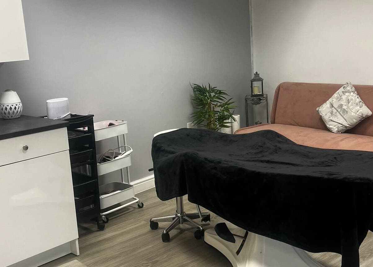 Relaxing treatment room at Timeless Cosmetics, King's Lynn, England, GB, showcasing a cozy couch and elegant decor.