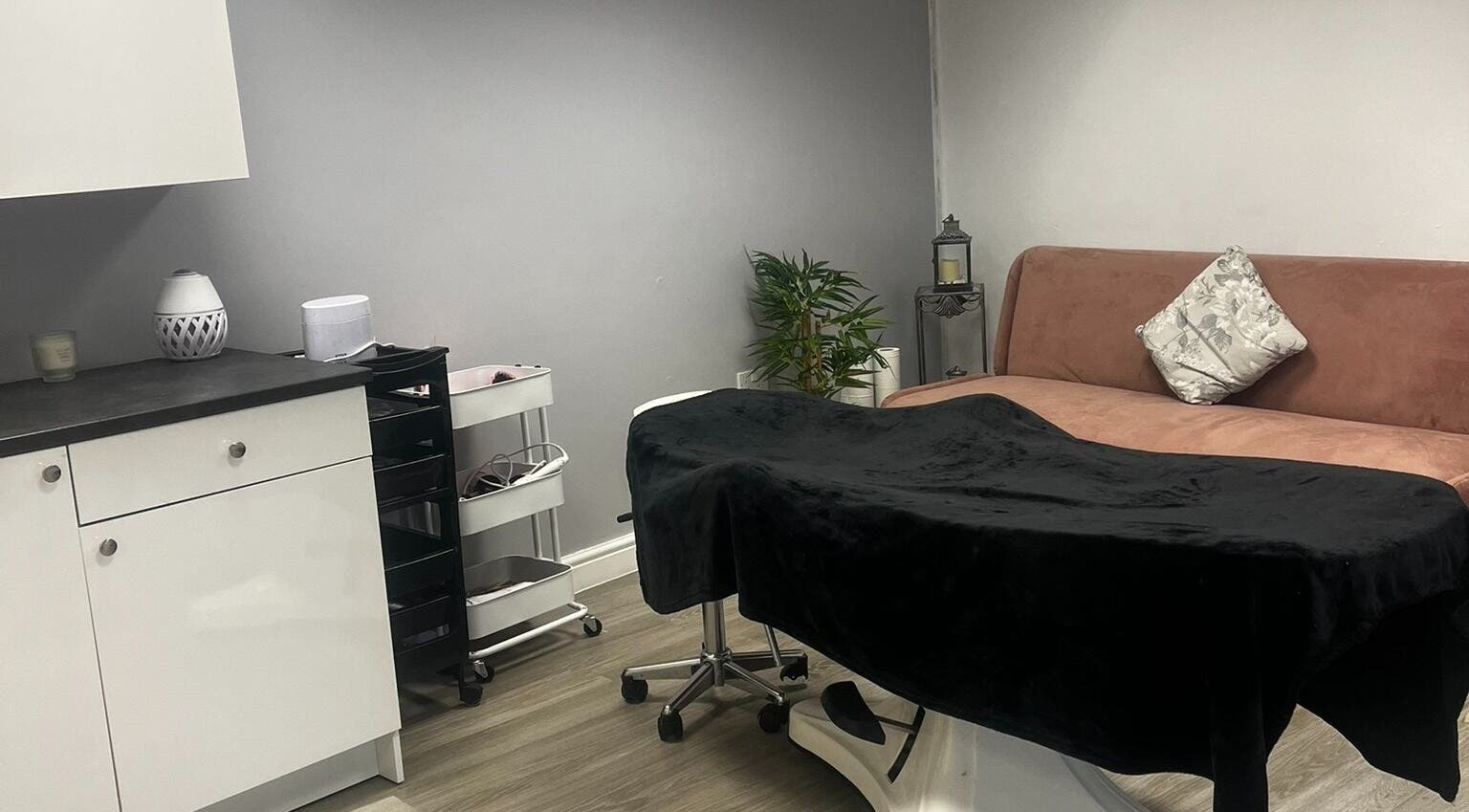 Relaxing treatment room at Timeless Cosmetics, King's Lynn, England, GB, showcasing a cozy couch and elegant decor.