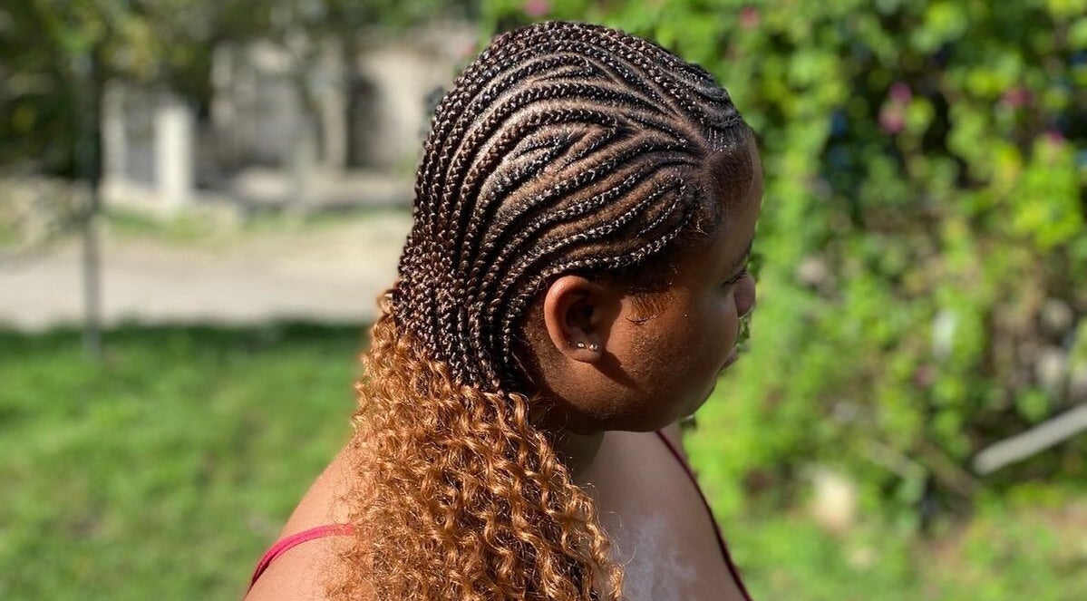 Intricate cornrow braids blending into curls at Tressed_bybrit, Montego Bay, St. James Parish, JM.