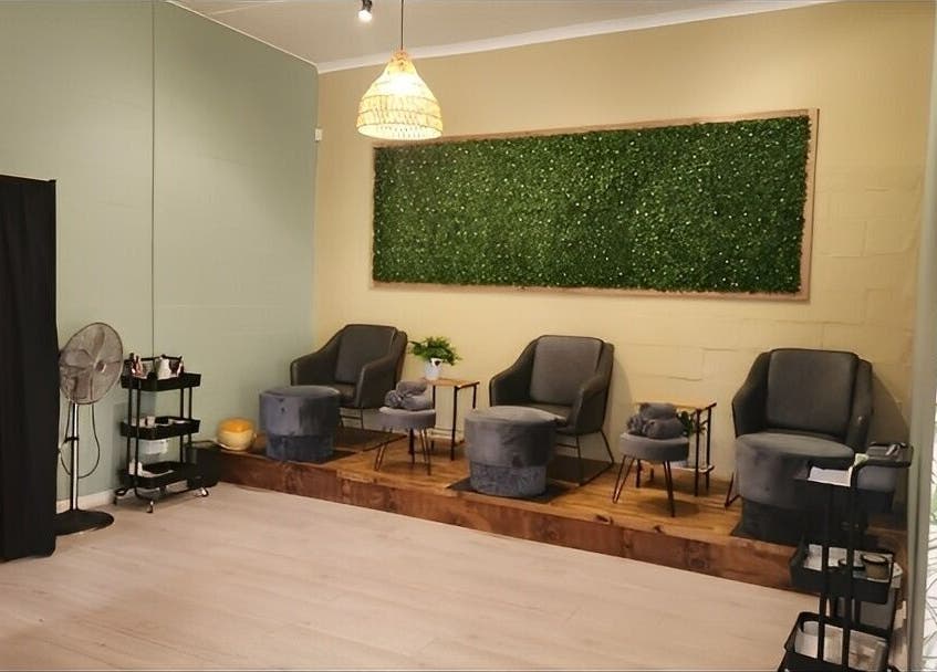Relaxing lounge area at Prim & Proper Salon and Spa, Cape Town, Western Cape, ZA with elegant chairs and decor.