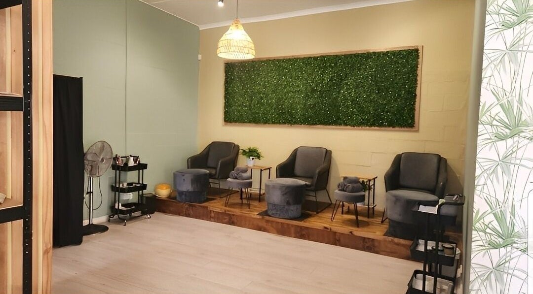 Relaxing lounge area at Prim & Proper Salon and Spa, Cape Town, Western Cape, ZA with elegant chairs and decor.