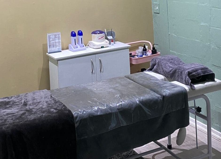 Relaxing treatment room at Prim & Proper Salon and Spa, Cape Town, Western Cape, ZA, featuring a cozy massage bed.