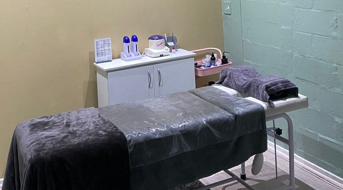 Relaxing treatment room at Prim & Proper Salon and Spa, Cape Town, Western Cape, ZA, featuring a cozy massage bed.