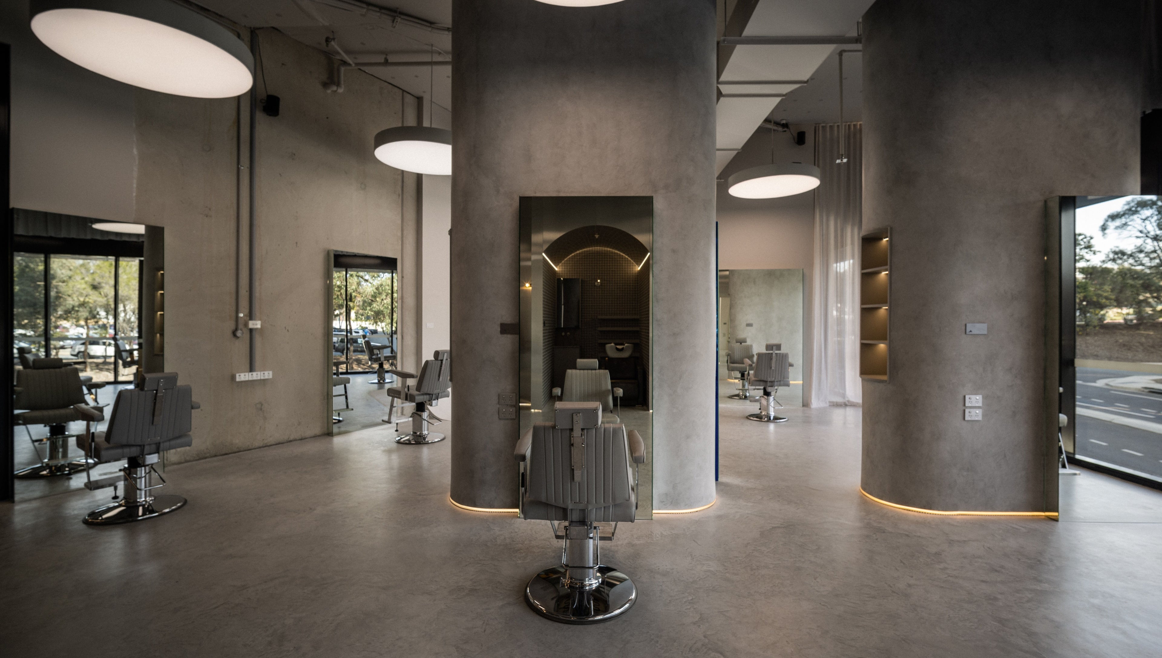 Spacious and modern interior of Alkami salon in Belconnen, Australian Capital Territory, AU, with sleek barber chairs.