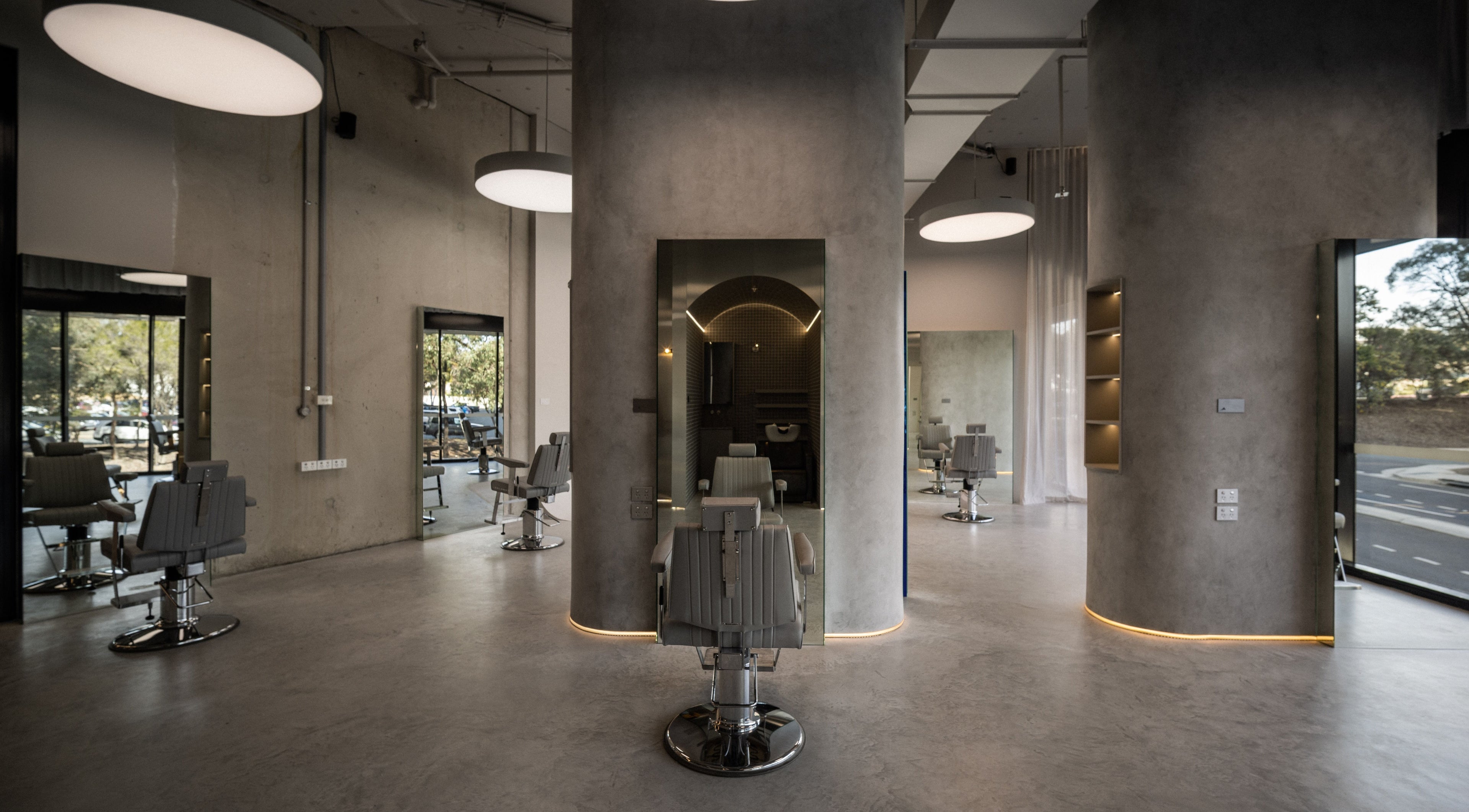 Spacious and modern interior of Alkami salon in Belconnen, Australian Capital Territory, AU, with sleek barber chairs.