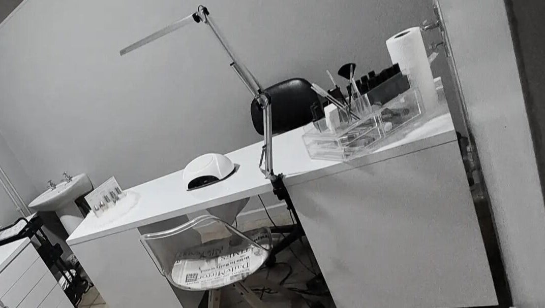 Nail salon workspace at C C Beauty Aesthetics, Pretoria, Gauteng, ZA, featuring manicure tools and ergonomic chair.