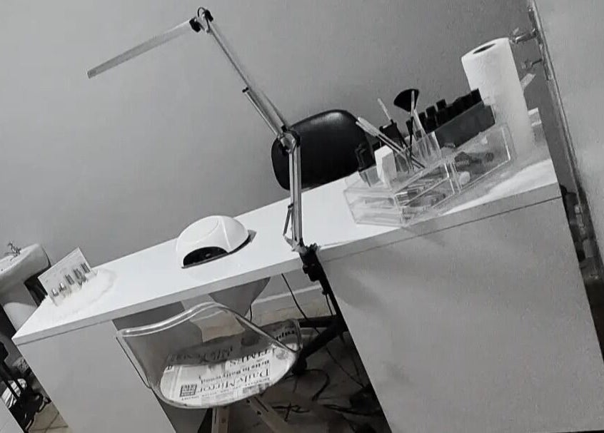 Nail salon workspace at C C Beauty Aesthetics, Pretoria, Gauteng, ZA, featuring manicure tools and ergonomic chair.