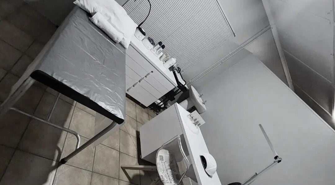 Calm treatment room at C C Beauty Aesthetics in Pretoria, Gauteng, ZA, featuring a treatment bed and white furnishings.