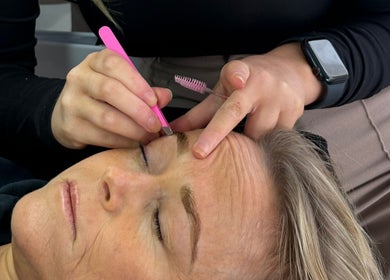 Enhance Beauty expert shaping eyebrows at Albion Park Rail, New South Wales, AU.