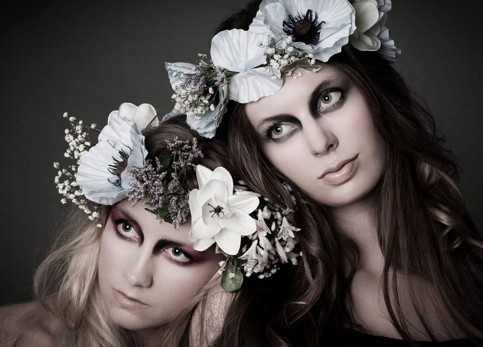 Two models with floral headpieces at Kelly Hair Studio inside Green Cactus cafe, London, England, GB.