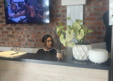 Reception desk with a staff member at Dr. Allison Aesthetics in Cape Town, Western Cape, ZA.