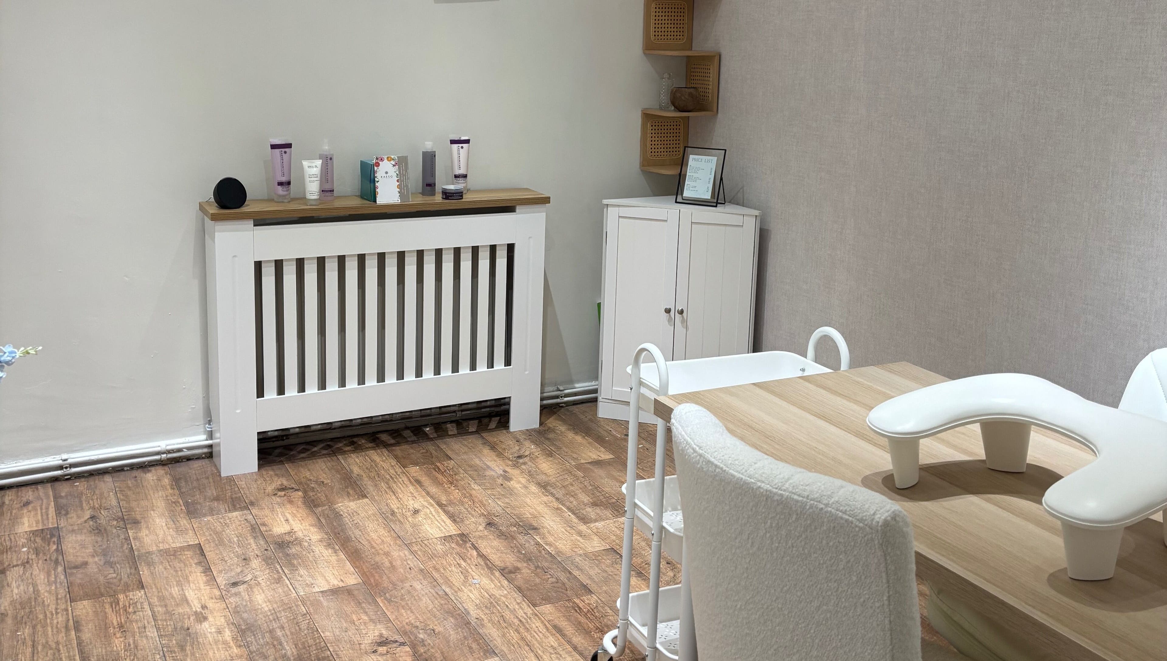 A tranquil beauty treatment room at By Ells, Redditch, England, GB with a modern table and skincare products.