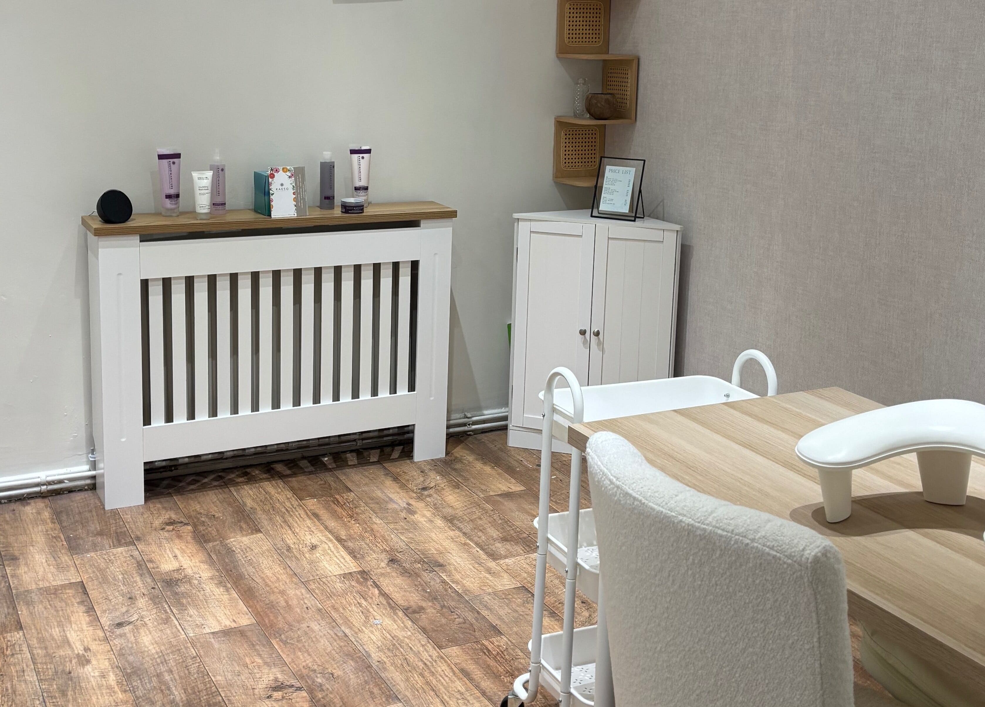 A tranquil beauty treatment room at By Ells, Redditch, England, GB with a modern table and skincare products.