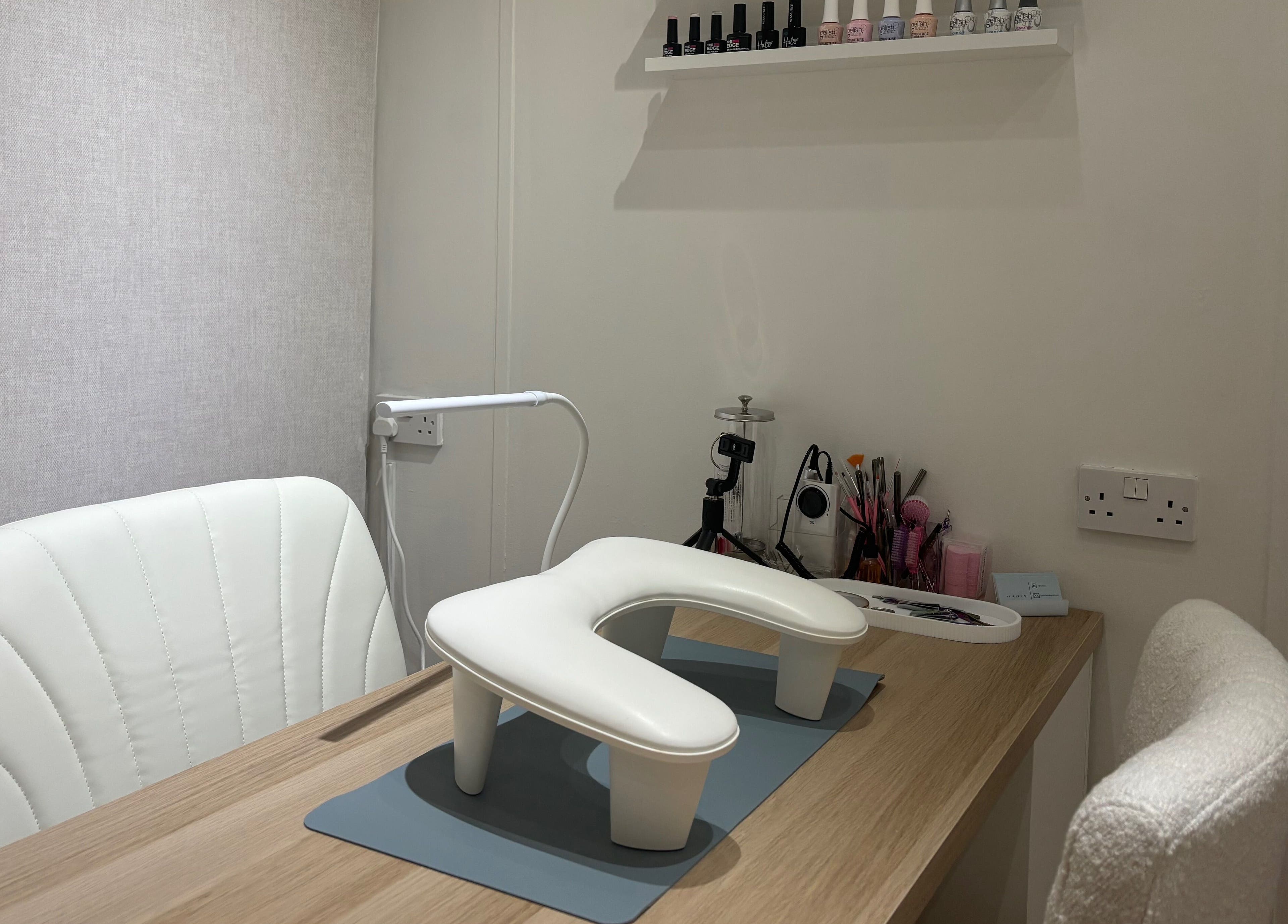 Nail station setup at By Ells, Redditch, England, GB with tools and white chairs.