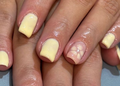 Elegant nail art with yellow polish and design at By Ells, Redditch, England, GB.